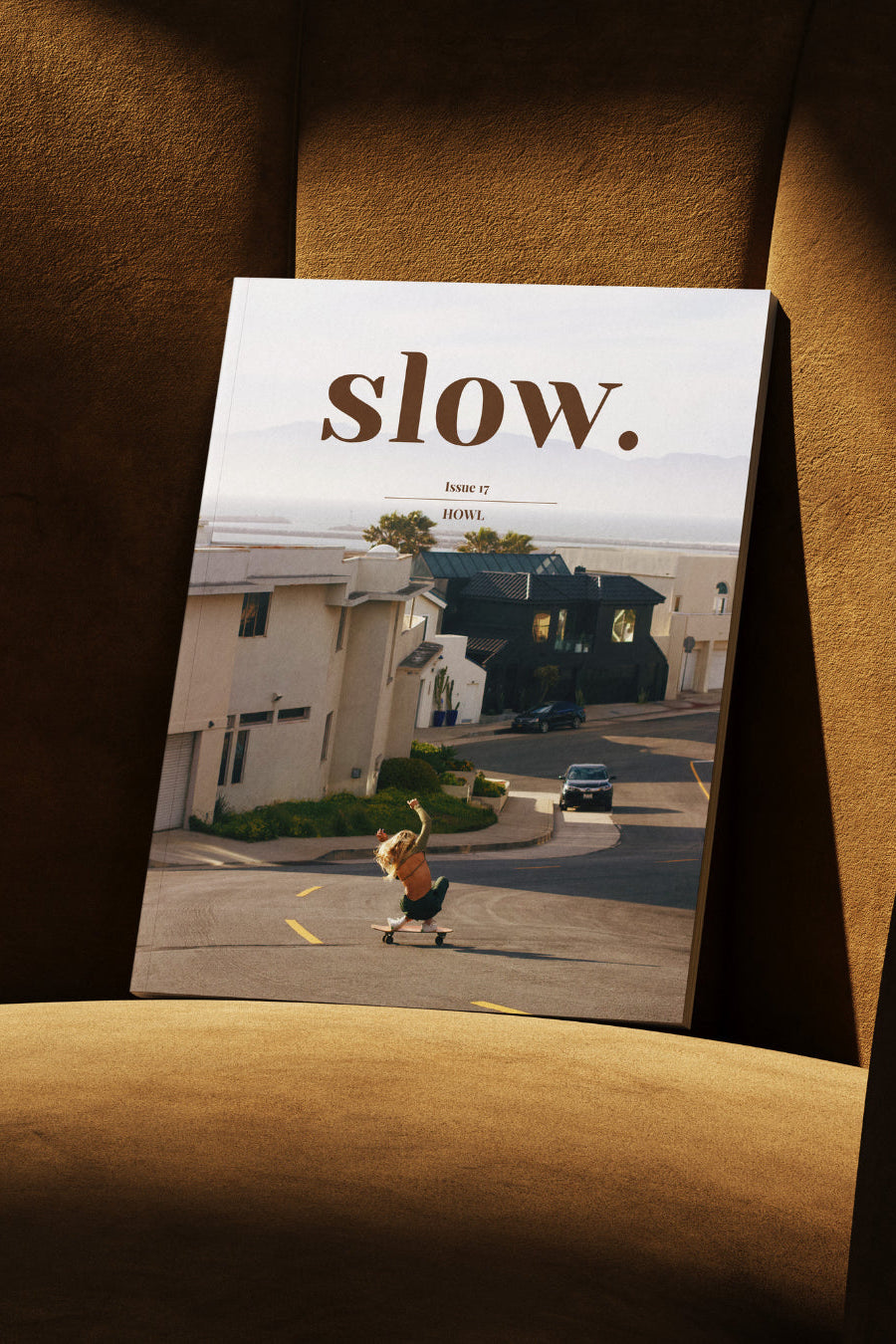 Magazine titled 'slow.' on a brown surface